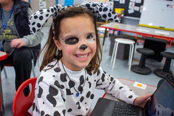 girl smiling dressed as dalmatian dog